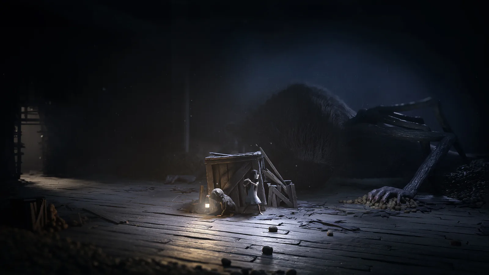 A giant creature reaches over the two kids hiding behind a crate